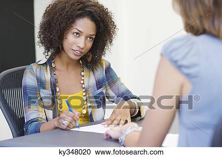 African American woman taking an interview of a woman View Large Photo Image Stock Image - African American woman taking an interview of a woman. Fotosearch