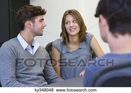 Couple meeting with an advisor View Large Photo Image Stock Photo - Couple meeting with an advisor. Fotosearch