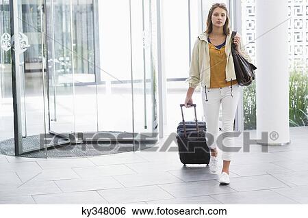 Portrait of a woman arriving in a hotel View Large Photo Image Stock Photograph - Portrait of a woman arriving in a hotel. Fotosearch
