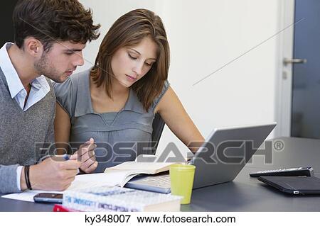 University students using laptop in classroom View Large Photo Image Stock Photo - University students using laptop in classroom. Fotosearch