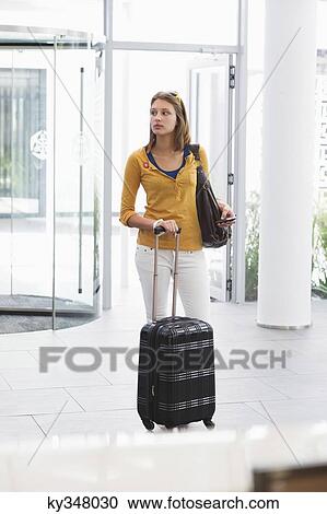 Stock Image - Woman arriving in a hotel. Fotosearch