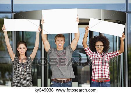 Angry friends protesting with blank placards View Large Photo Image Stock Photo - Angry friends protesting with blank placards. Fotosearch