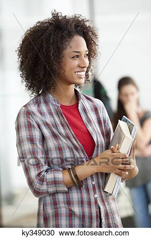 Close-up of a female university student smiling View Large Photo Image Stock Image - Close-up of a female university student smiling. Fotosearch