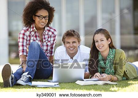 Stock Image - Friends studying in a campus. Fotosearch