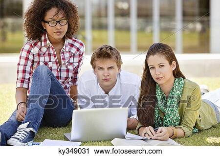 Stock Image - Friends studying in a campus. Fotosearch