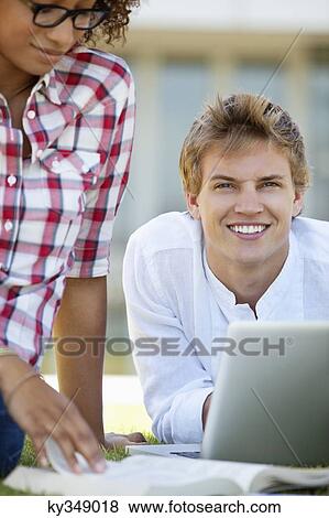 Stock Photo - Friends studying in a campus. Fotosearch
