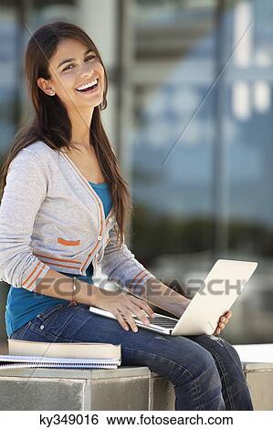 Stock Photograph - Portrait of a woman using a laptop. Fotosearch