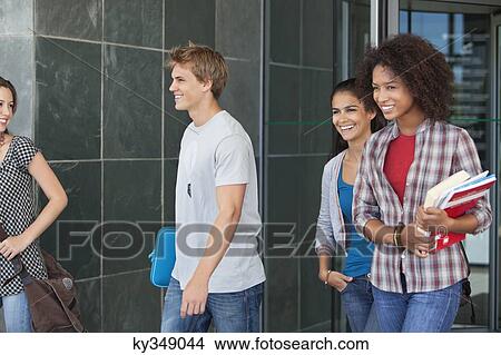 Smiling university students walking in campus View Large Photo Image Picture - Smiling university students walking in campus. Fotosearch