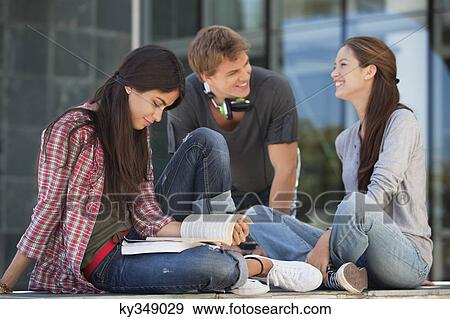 Smiling young students having discussion View Large Photo Image Stock Photo - Smiling young students having discussion. Fotosearch
