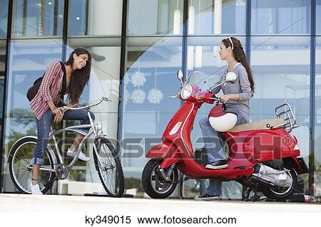 Stock Photography - Two female friends having a friendly conversation. Fotosearch