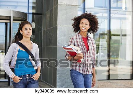 Two female friends walking in campus View Large Photo Image Stock Photography - Two female friends walking in campus. Fotosearch
