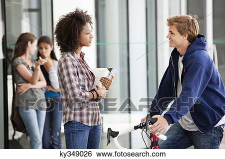 Two friends discussing in campus View Large Photo Image Stock Photograph - Two friends discussing in campus. Fotosearch