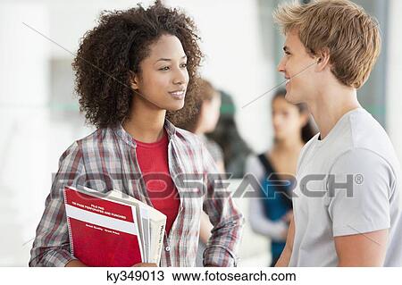 Two university students discussing in campus View Large Photo Image Stock Image - Two university students discussing in campus. Fotosearch