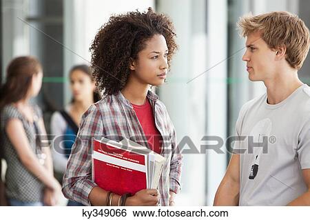 Stock Photograph - Two university students discussing in campus. Fotosearch
