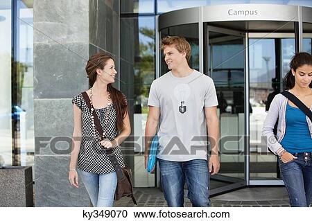 Stock Image - University students walking in a campus. Fotosearch