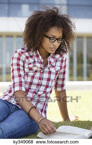 Stock Photo - Woman studying in a campus. Fotosearch