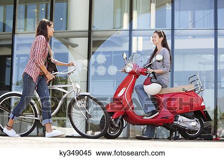 Stock Photography - Young women having a conversation. Fotosearch