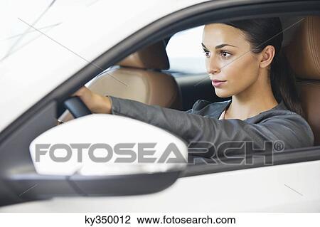 Beautiful young woman taking a test drive View Large Photo Image Stock Image - Beautiful young woman taking a test drive. Fotosearch