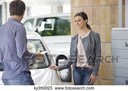 Couple buying a car in showroom View Large Photo Image Stock Image - Couple buying a car in showroom. Fotosearch