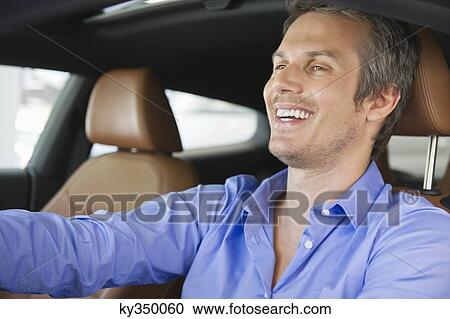 Happy mid adult man taking a test drive View Large Photo Image Stock Image - Happy mid adult man taking a test drive. Fotosearch