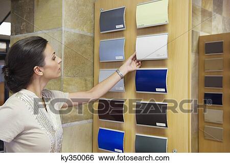 Young woman looking at color samples at car showroom View Large Photo Image Stock Photograph - Young woman looking at color samples at car showroom. Fotosearch