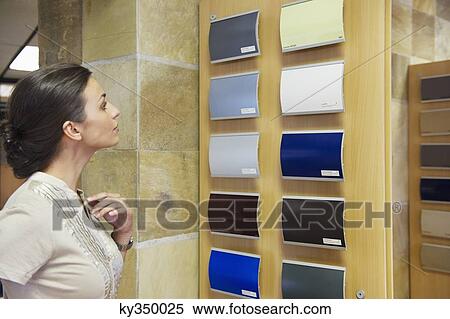 Young woman looking at color samples at car showroom View Large Photo Image Stock Photography - Young woman looking at color samples at car showroom. Fotosearch