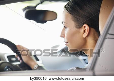 Young woman taking a test drive View Large Photo Image Stock Photograph - Young woman taking a test drive. Fotosearch