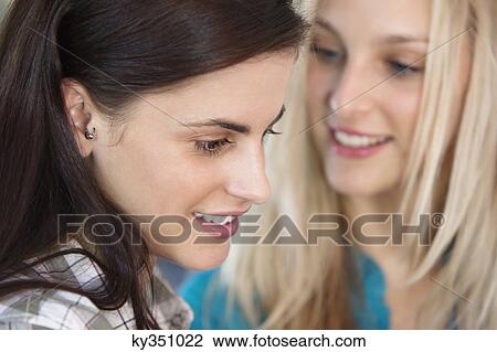 Close-up of female friends smiling View Large Photo Image Stock Image - Close-up of female friends smiling. Fotosearch