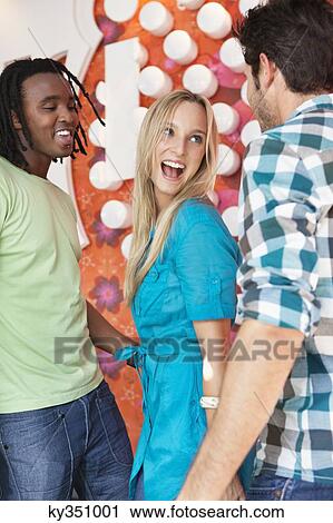 Stock Image - Friends enjoying in a bar. Fotosearch