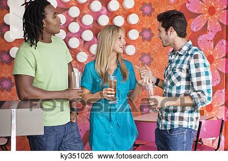 Friends having drinks at a bar View Large Photo Image Stock Photograph - Friends having drinks at a bar. Fotosearch