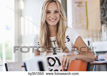 Portrait of a beautiful woman smiling in a cafe View Large Photo Image Stock Photography - Portrait of a beautiful woman smiling in a cafe. Fotosearch