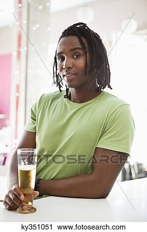 Portrait of a man having beer at a bar View Large Photo Image Stock Image - Portrait of a man having beer at a bar. Fotosearch