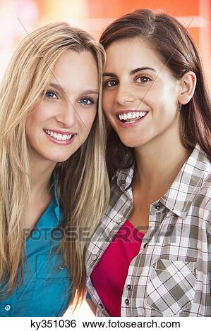 Portrait of beautiful female friends smiling View Large Photo Image Stock Photograph - Portrait of beautiful female friends smiling. Fotosearch