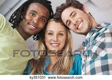 Stock Image - Portrait of friends enjoying in a bar. Fotosearch