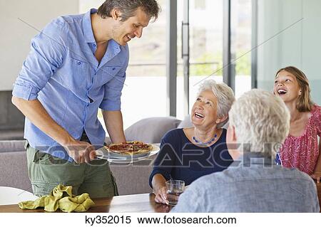 Family at a dining table View Large Photo Image Stock Photography - Family at a dining table. Fotosearch