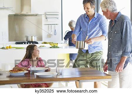 Multi-generation family eating food at home View Large Photo Image Stock Photography - Multi-generation family eating food at home. Fotosearch