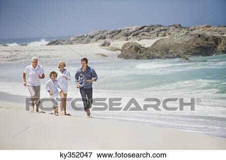 Multi generation family running on the beach View Large Photo Image Stock Photo - Multi generation family running on the beach. Fotosearch