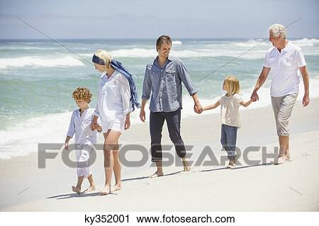 Multi generation family walking on the beach View Large Photo Image Stock Image - Multi generation family walking on the beach. Fotosearch