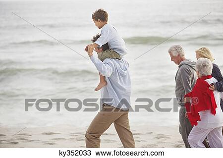 Multi-generation family walking on the beach View Large Photo Image Stock Image - Multi-generation family walking on the beach. Fotosearch