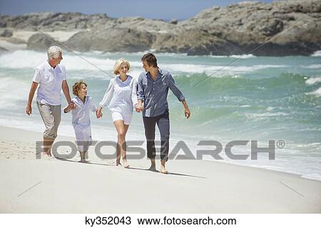 Multi generation family walking on the beach View Large Photo Image Stock Image - Multi generation family walking on the beach. Fotosearch