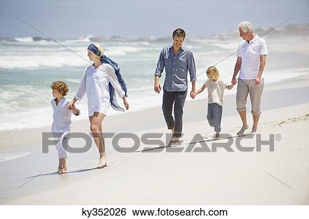 Multi generation family walking on the beach View Large Photo Image Stock Photograph - Multi generation family walking on the beach. Fotosearch