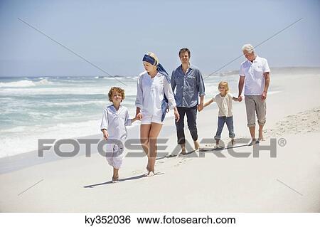 Multi generation family walking on the beach View Large Photo Image Stock Photograph - Multi generation family walking on the beach. Fotosearch
