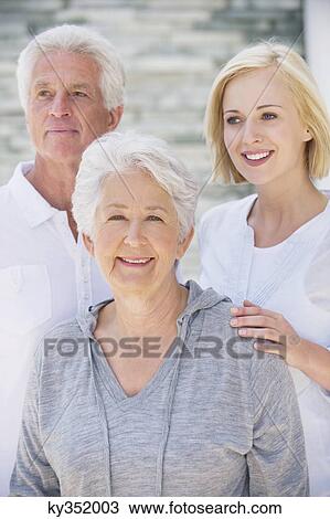 Young woman smiling with her parents View Large Photo Image Stock Image - Young woman smiling with her parents. Fotosearch