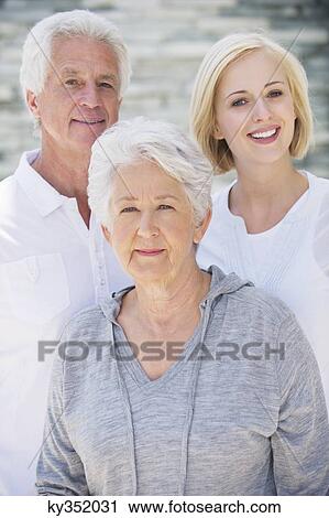 Young woman smiling with her parents View Large Photo Image Stock Image - Young woman smiling with her parents. Fotosearch