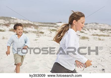 Boy playing with his sister on the beach View Large Photo Image Stock Photo - Boy playing with his sister on the beach. Fotosearch