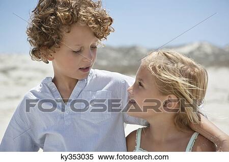 Close-up of brother and sister looking at each other View Large Photo Image Stock Photography - Close-up of brother and sister looking at each other. Fotosearch