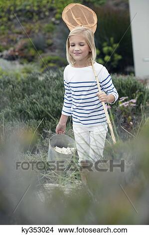 Girl carrying net and bucket for fishing View Large Photo Image Picture - Girl carrying net and bucket for fishing. Fotosearch