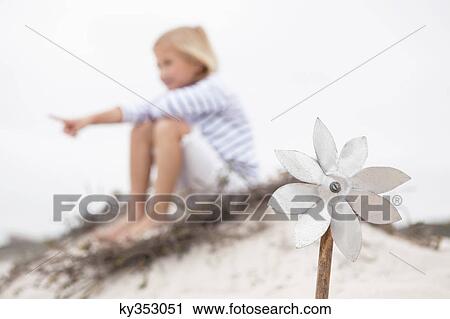 Pinwheel with girl pointing at something in the background View Large Photo Image Stock Image - Pinwheel with girl pointing at something in the background. Fotosearch