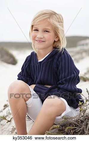 Portrait of a cute girl wearing sweater View Large Photo Image Stock Photograph - Portrait of a cute girl wearing sweater. Fotosearch