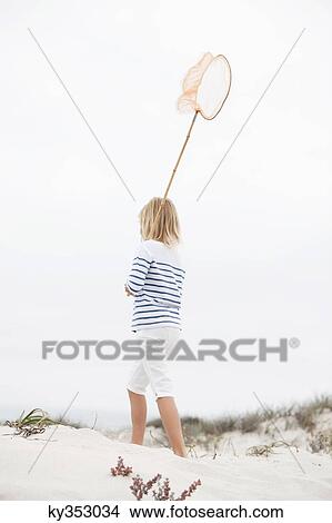 Rear view of a girl holding net View Large Photo Image Picture - Rear view of a girl holding net. Fotosearch